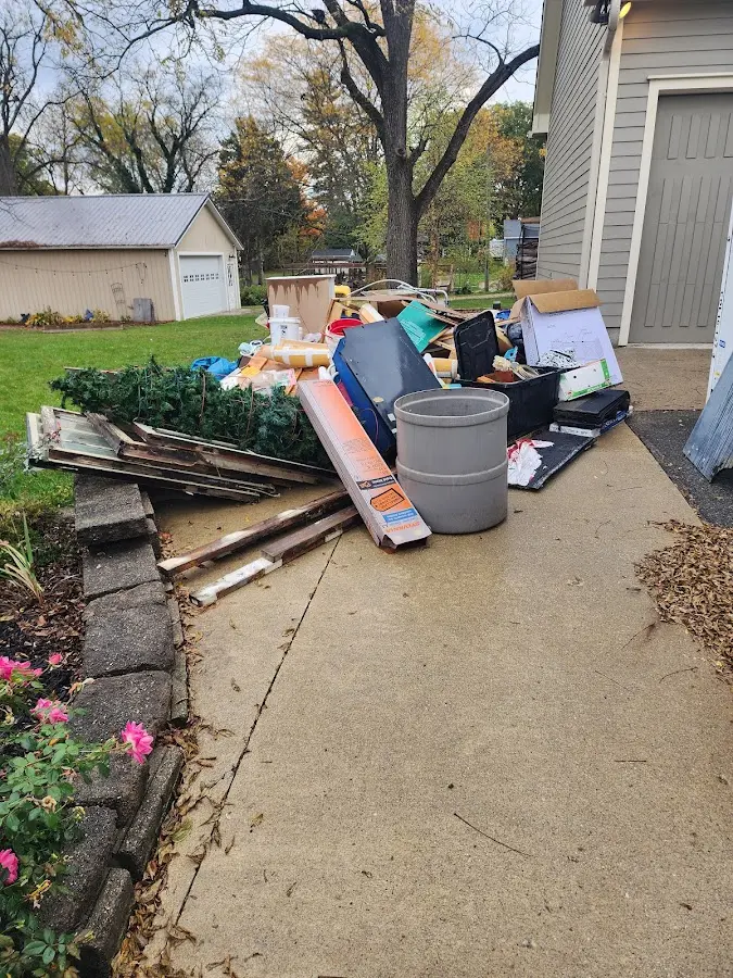 Dumpster being loaded with debris for 10 Yard Dumpster Rental in Hamilton
